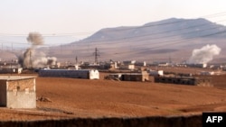 FILE - Smoke rises from bombardment amid battles between the Turkish-backed Syrian National Army faction and the Kurdish-led Syrian Democratic Forces at a position near the Tishrin Dam in the vicinity of Manbij, in the east of Syria's northern Aleppo province, Jan. 10, 2025.