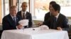 US President Donald Trump speaks with Japan's Prime Minister Shinzo Abe during a luncheon at the Kasumigaseki Country Club Gold Course in Tokyo, Nov. 5, 2017. The president and prime minister signed white hats reading “Donald and Shinzo Make Alliance Even