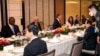 China Defense Minister Wei Fenghe, center right, talks with U.S. Secretary of Defense Lloyd Austin, left, during the 19th International Institute for Strategic Studies Shangri-la Dialogue, in Singapore, June 11, 2022.