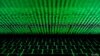 FILE - This photo illustration shows a computer keyboard lit by displayed cyber code.
