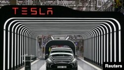 In this file photo, Model Y cars are shown during the opening ceremony of the new Tesla Gigafactory for electric cars in Gruenheide, Germany, March 22, 2022. (Patrick Pleul/Pool via REUTERS)