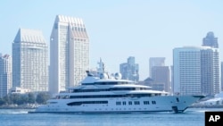 FILE - The superyacht Amadea passes San Diego as it comes into the San Diego Bay, seen from Coronado, California, June 27, 2022. The $325 million superyacht was seized by the United States from a sanctioned Russian oligarch.