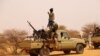 FILE - An anti-aircraft gun is mounted on the back of a pickup truck as militants from a Tuareg political and armed movement in the Azawad Region in Mali gather in the desert outside Menaka, March 14, 2020.