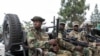FILE - M23 rebels escort soldiers from Democratic Forces for the Liberation of Rwanda, not pictured, to the Rwandan border for repatriation after capture in Goma at the Goma-Gisenyi Grande Barrier border crossing, March 1, 2025.