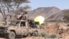 FILE - Houthi fighters fire a machine gun mounted on a truck at a frontline in al-Jubah district of Yemen's Marib province in a frame grab from video handed out by the Houthis' media center. Nov. 2, 2021.