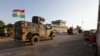 FILE - Iraqi and Kurdish fighters take part in an intensive security deployment after Islamic State militants took over a village in Kirkuk the previous day, Dec. 6, 2021. A recent joint operation occurred in the Gharaw Palkana area of Khurmatu district, a known ISIS stronghold.