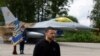 FILE P- Ukraine's President Zelenskiy speaks to the media in a front of an F-16 fighter jet at an undisclosed location in Ukraine, Aug. 4, 2024. 