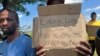 Protesters carrying placards expressing dismay over xenophobia attacks