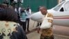 A Kenyan soldier, who Kenya Defence Forces said was injured in the attack by al-Shabab in Somalia walks from an airplane to a waiting ambulance after being airlifted back to Nairobi for medical treatment, Jan. 17, 2016. 