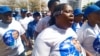 Supporters of the opposition coalition Umbrella for Democratic Change sing outside the high court in Gaborone, Botswana, during presidential nominations on Sept. 28, 2024.