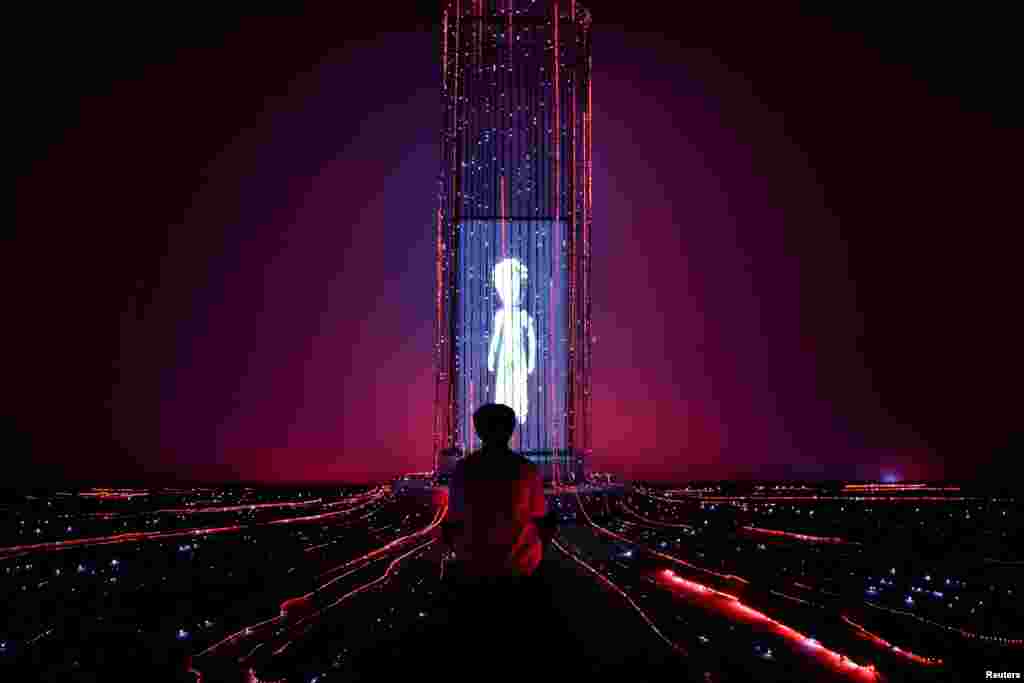 A man sits attends "The Little Prince Universe — An Immersive Journey," a show of mixed digital interactive experiences and installations, based on Antoine de Saint-Exupery's novella "The Little Prince," in Bangkok, Thailand.