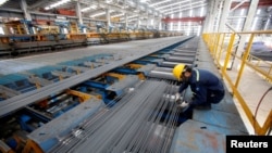 A man checks steel quality at Hoa Phat steel mill in Hai Duong province, Vietnam June 14, 2016.