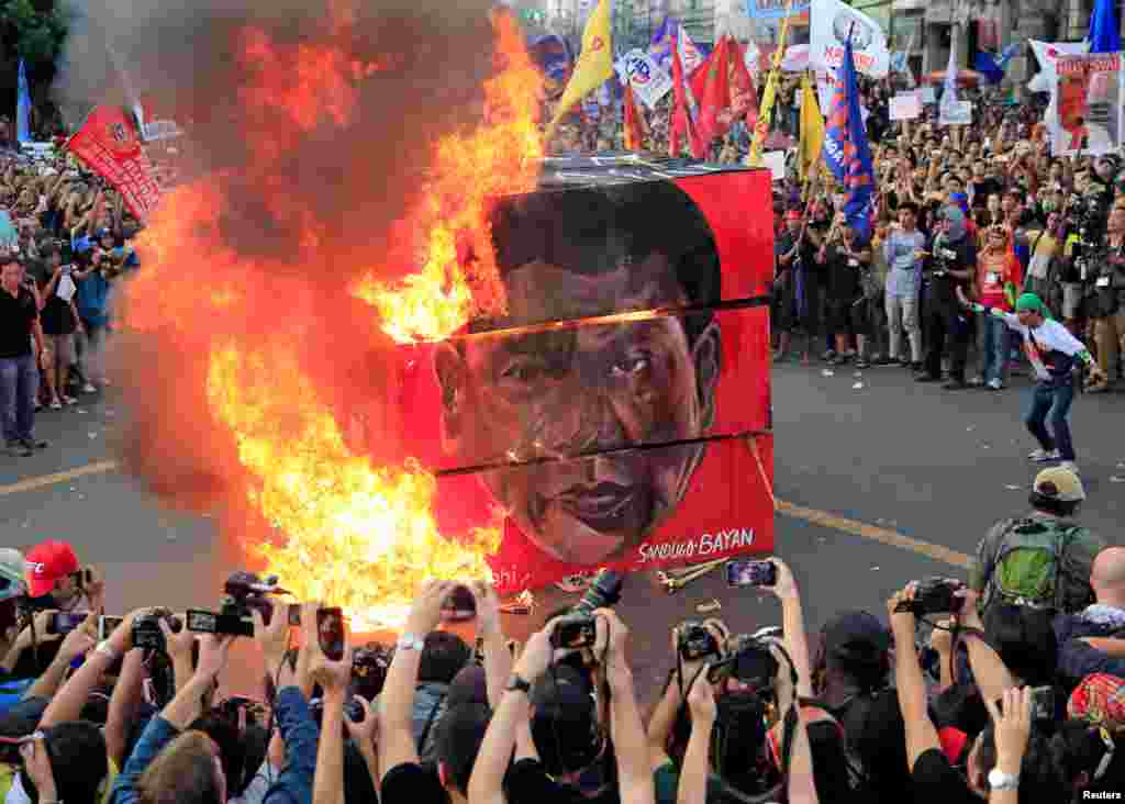 Protesters burn an effigy with a face of President Rodrigo Duterte during a National Day of Protest outside the presidential palace in metro Manila, Philippines.