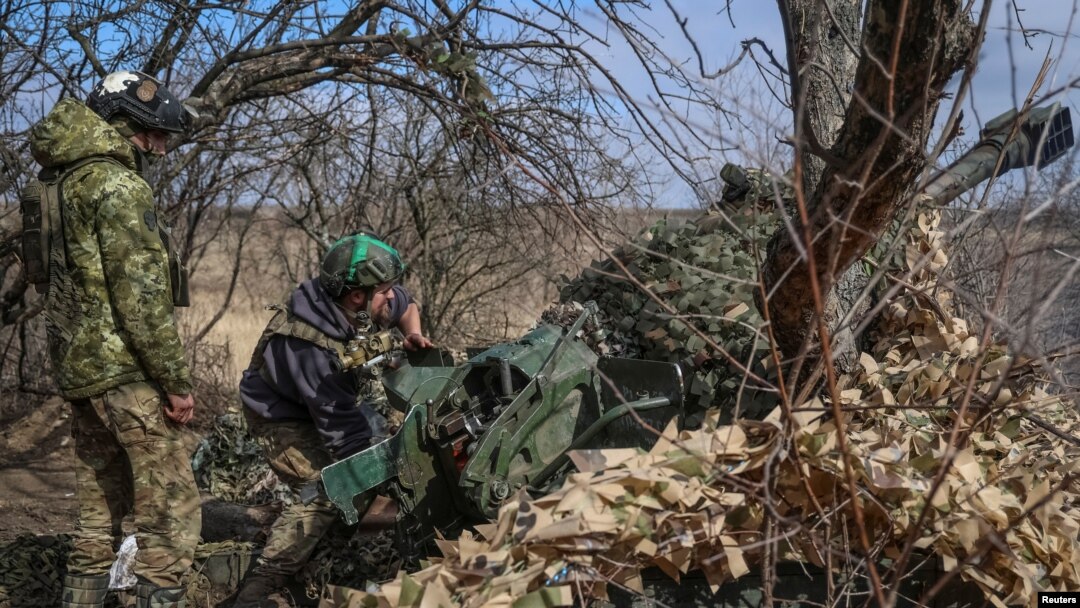 Ukrainian service members fire a 120 mm mortar toward Russian troops near the town of Bakhmut in the Donetsk region of Ukraine on March 8, 2024.