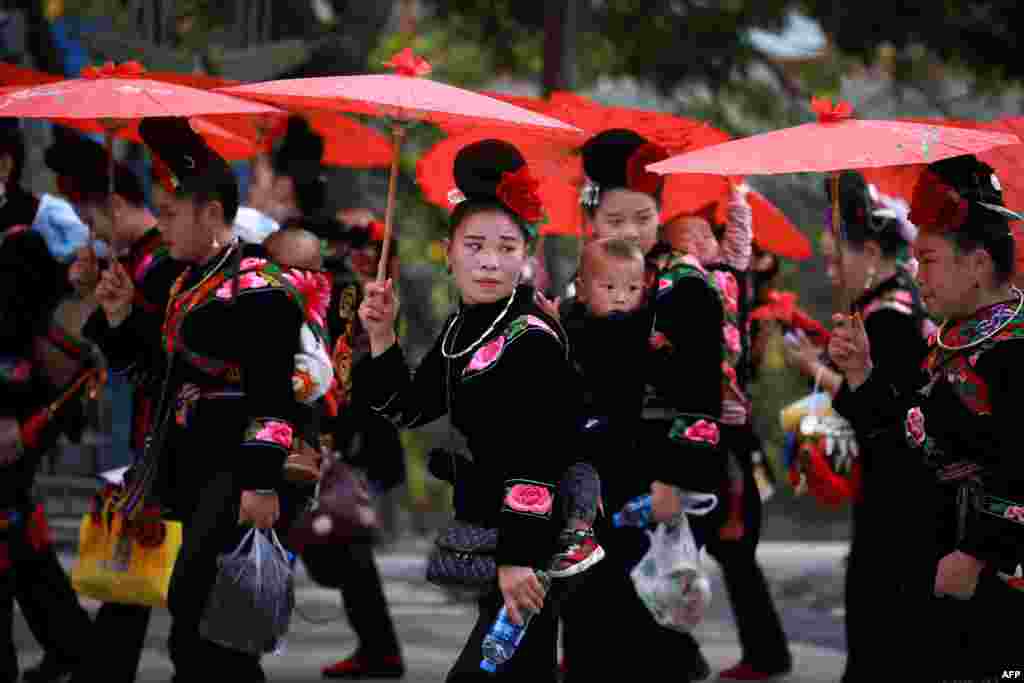 Women of the Miao ethnic minority in traditional costumes parade to celebrate the Miao new year festival in Leishan county, in China's southwestern Guizhou province, Nov. 18, 2020.