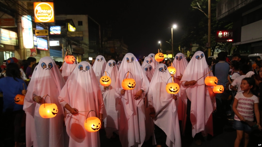 People wear ghost costumes as they join a Halloween Parade in the Philippines, 2013. (AP Photo/Aaron Favila)