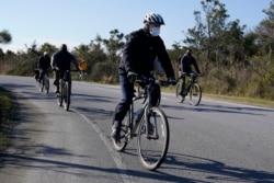Joe Biden rides a bike at Cape Henlopen State Park on Saturday, Nov. 14, 2020, in Lewes, Del. (AP Photo/Alex Brandon)