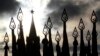 FILE - Russian servicemen (not pictured) hold flags with pikes topped with hammers and sickles, symbolic of Soviet times, with a Kremlin tower seen in the background, during a military parade rehearsal in Red Square in Moscow, Russia, Nov. 5, 2012.