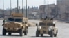 Syrian Democratic Forces (SDF) patrol a street in the northern Syrian city of Hasakeh, Jan. 23, 2022.
