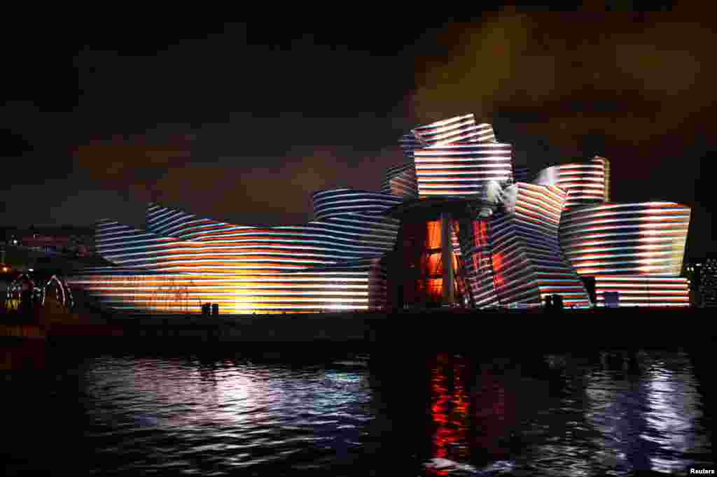 The Guggenheim museum is illuminated by the light show Reflections, part of the 20th anniversary celebrations in Bilbao, Spain, Oct. 11, 2017.