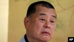 FILE - Hong Kong media tycoon Jimmy Lai pauses during an interview in Hong Kong, July 1, 2020. Lai's court appearance on Wednesday marked the first time the former publisher provided testimony in a high-profile trial that started nearly one year ago.