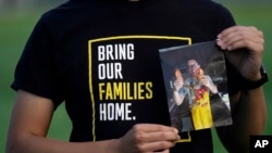 FILE - Harrison Li holds a photo of his father, Kai Li, as he poses for a photo, Tuesday, Jan. 23, 2024, in Palo Alto, Calif. 