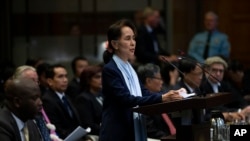 Myanmar's leader Aung San Suu Kyi addresses judges of the International Court of Justice for the second day of three days of hearings in The Hague, Netherlands, Wednesday, Dec. 11, 2019. Aung San Suu Kyi will represent Myanmar in a case filed by Gambia at the ICJ, the United Nati