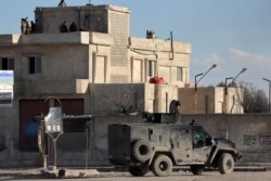 Members of the Syrian Democratic Forces (SDF) deploy around Ghwayran prison in Syria's northeastern city of Hasake, Jan. 25, 2022, which was taken over by Islamic State (IS) group fighters days earlier.