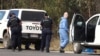 FILE - Police work near the scene of a fatal shooting, where police shot multiple people at a remote Queensland property after an ambush in which two officers and a bystander were also killed, in Wieambilla, Australia, Dec. 13, 2022. 