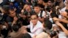 FILE- Thailand Prime Minister Prayuth Chan-ocha amid a crush of press photographers.