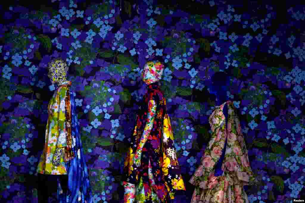 Models prepare to display Richard Quinn's Spring/Summer 2018 show in the Liberty Store at London Fashion Week in London, Sept. 16, 2017.