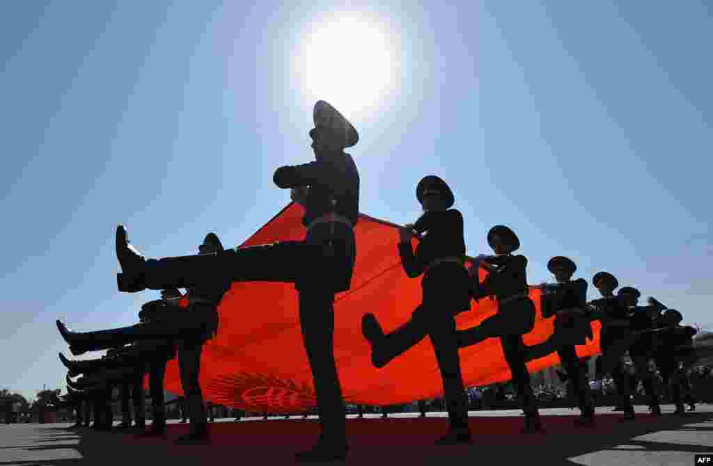 Kyrgyz honor guards carry their national flag as they parade during celebrations marking the 26th anniversary of Kyrgyzstan's independence from the Soviet Union, at the Ala-Too Square in Bishkek.
