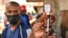 FILE - A health official prepares the Moderna COVID-19 vaccine during a mass Covid-19 vaccination drive in Nairobi, Kenya, Sept. 17, 2021.