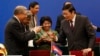 FILE - Chinese Finance Minister Lou Jiwei, right, toasts with guests at the signing ceremony of the Asian Infrastructure Investment Bank in Beijing, Oct. 24, 2014. 