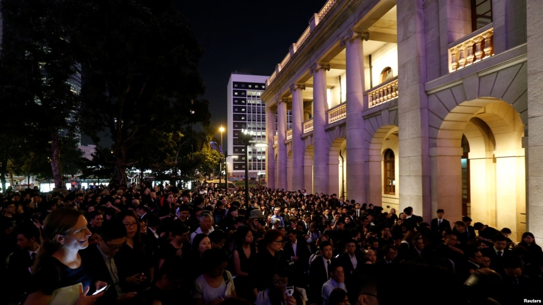 FILE - Hundreds of members from the legal sector stage a silent protest outside the Court of Final Appeal, against Beijing's most direct intervention in Hong Kong's legal and political system since the 1997 handover, in Hong Kong, China, Nov. 8, 2016.
