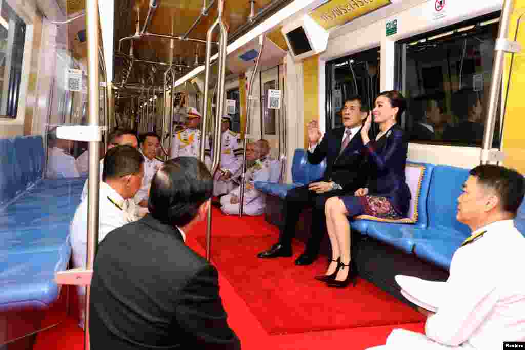 Thailand's King Maha Vajiralongkorn and Queen Suthida ride on an MRT during an inauguration of a new subway station in Bangkok.