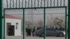 FILE - Residents line up inside a vocational training center in Artux, in western China's Xinjiang region, Dec. 3, 2018. Critics say China uses some of these facilities as detention camps for forced labor. 