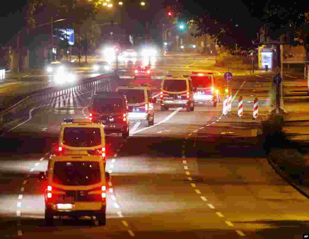 Police cars drive on an almost deserted street during an evacuation of more than 60,000 people in Frankfurt, Germany. The evacuation became necessary because of an unexploded 1.8 ton WW II bomb that will be diffused later in the day.