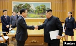 North Korean leader Kim Jong Un greets Chung Eui-yong, head of the presidential National Security Office, in Pyongyang, North Korea, March 6, 2018.