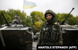 UKRAINE – A Ukrainian female soldier poses at a camp near the village of Luhanske in the Donetsk region, September 24, 2014