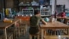 This photo taken on June 4, 2024 shows "Khaing," a former teacher with the Civil Disobedience Movement (CDM), sitting in a restaurant where she works after fleeing from Myanmar to Thailand to avoid conscription by Myanmar's military junta, in Bangkok.