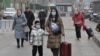 People walk on a street in Beijing on Jan. 17, 2024. China's population decline accelerated in 2023, official data showed, extending a downward streak after more than six decades of growth as the country battles a looming demographic crisis. 