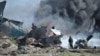 FILE - African Union Mission in Somalia soldiers attempt to extinguish the fire at the site of an airplane crash in Mogadishu, Somalia. (AMISOM) 
