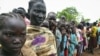 Female child refugees who escaped violence on Sudan's side of the disputed border queue up inside Yida refugee camp, South Sudan, June 30, 2012.