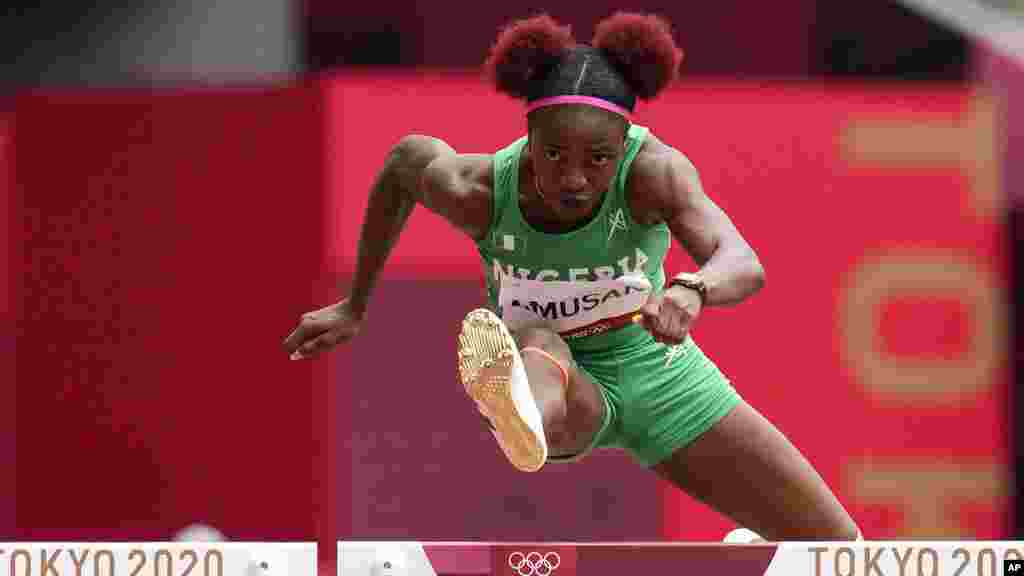 Tobi Amusan, of Nigeria, wins a heat in the women's 100-meter hurdles at the 2020 Summer Olympics, Saturday, July 31, 2021, in Tokyo. (AP Photo/Petr David Josek)