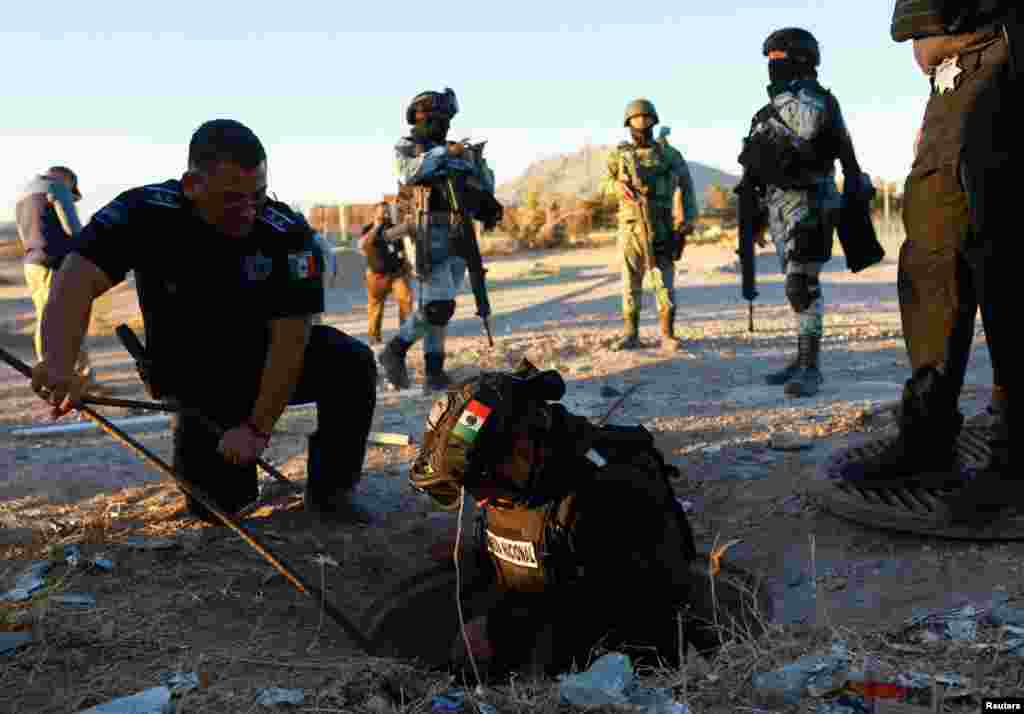 Mexican authorities inspect a culvert, which they believe is used by people to illegally cross into the United States from Mexico, in Ciudad Juarez, Feb. 4, 2025.