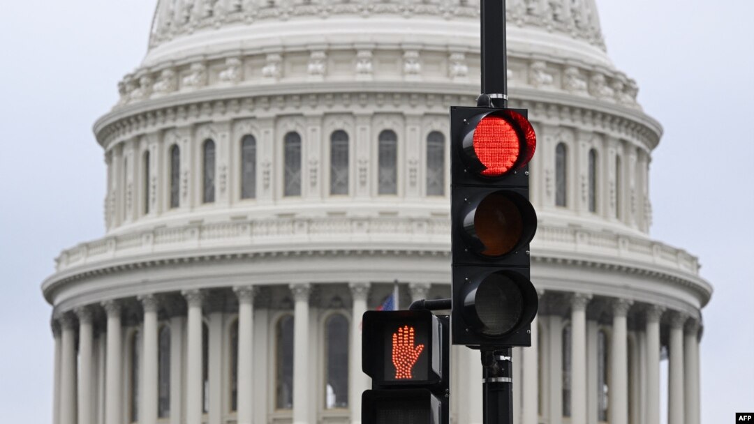 A stoplight is seen in front of the dome of the US Capitol as a government shut down looms in Washington, DC, on September 28, 2023.