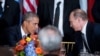 President Barack Obama and Russian President President Vladimir Putin greet each other during a luncheon, Monday, Sept. 28, 2015, at United Nations headquarters.