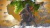 FILE - A Somali soldier stands guard next to the site where al-Shabab militants carried out a suicide attack against a military intelligence base in Mogadishu, June 2015.
