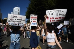 Protesters take part in the Women's March and Rally for Abortion Justice, in Los Angeles, California, Oct. 2, 2021.